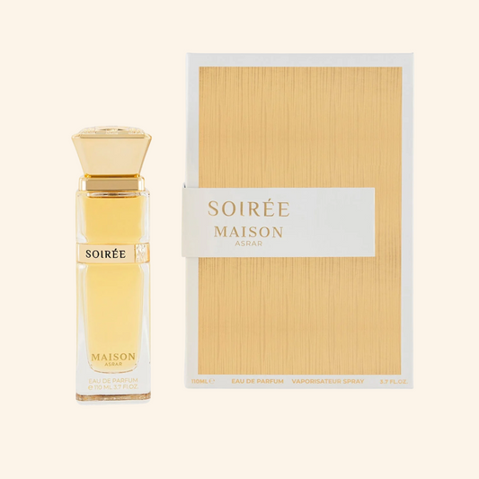 Perfume bottle and packaging of 'Soirée Maison' on a beige background. Discover Maison Asrar Soiree UK. A decadent unisex EDP with praline, plum, caramel & an ambergris vibe. A stunning Eilish alternative. Shop now at Nurabliss!