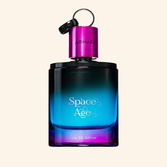 Armaf Space Age perfume bottle with blue and purple gradient on a beige background. Discover Armaf Space Age 100ml. A modern men's EDP blending bergamot, rose, jasmine, patchouli & vanilla. A sophisticated unisex scent. Shop now at Nurabliss!