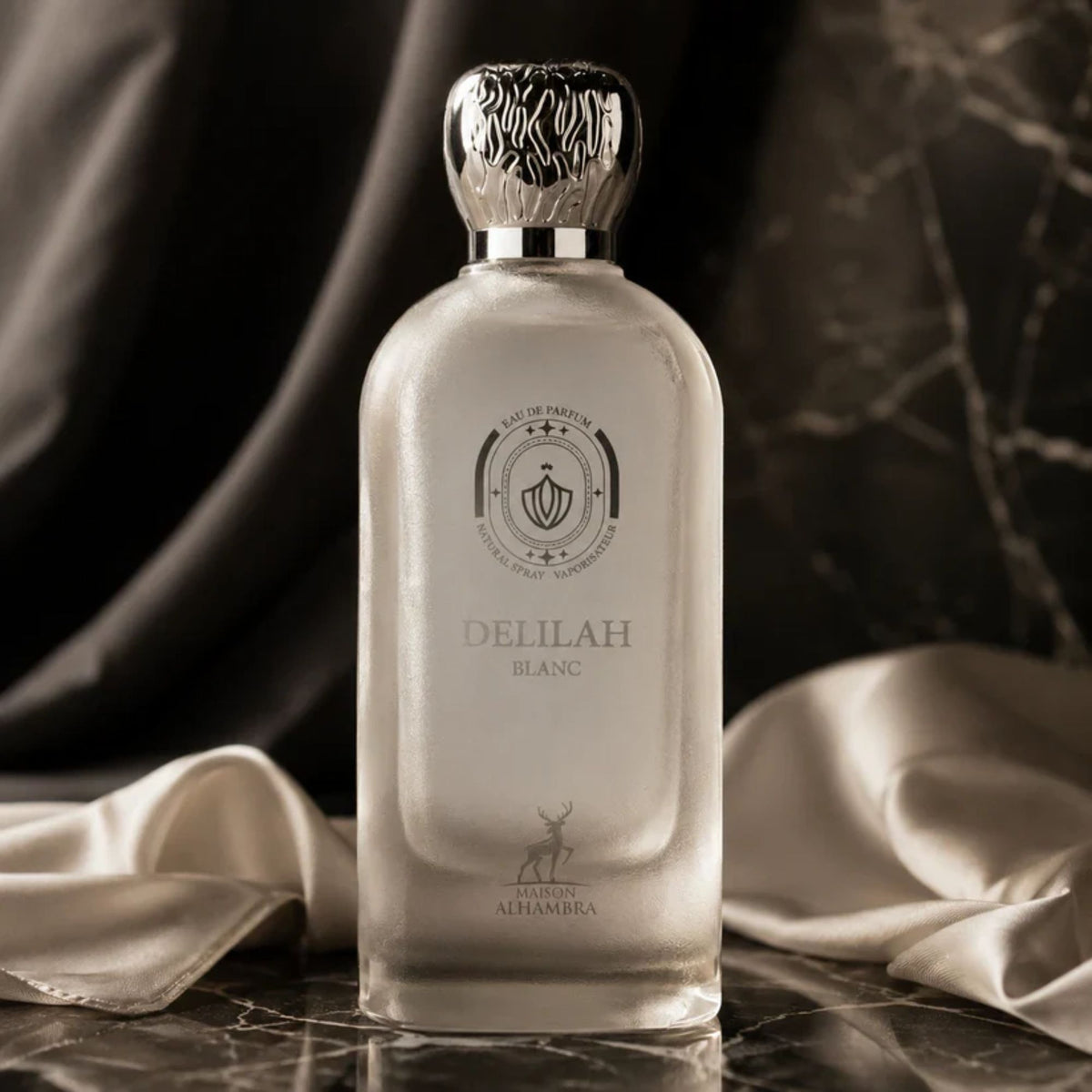 Shop Maison Alhambra Delilah Blanc 100ml EDP for Women. A vivid blend of juicy white peach, bergamot, orange blossom, crisp vetiver, vanilla, and white musk.