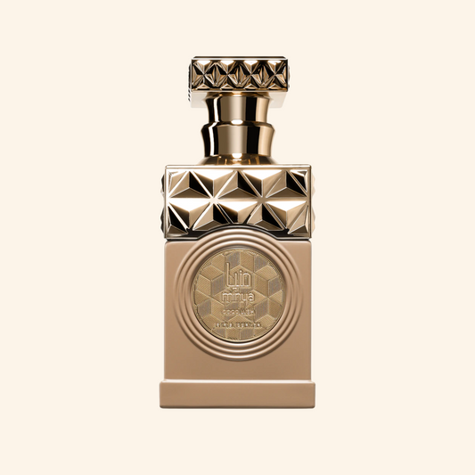 Gold perfume bottle with geometric design on a beige background. Discover Paris Corner Minya Coco Lush UK. A fun, creamy gourmand EDP with coconut milk, raspberry & macarons. An  Thank U, Next alternative. Shop now!
