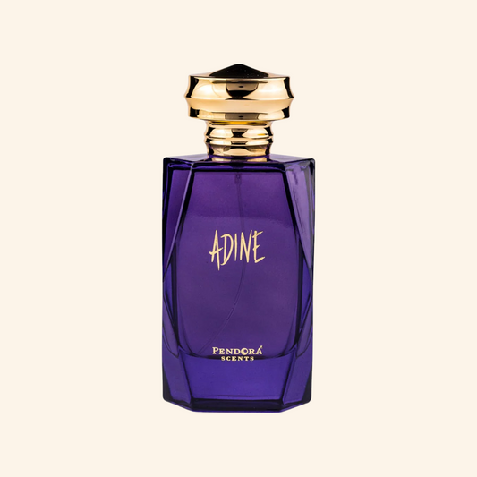 Purple perfume bottle with gold cap on a white background. Discover Pendora Scents by paris corner Adine . An iconic women's EDP with jasmine, cashmere wood & white amber. A stunning Alien alternative. Shop now nurabliss!